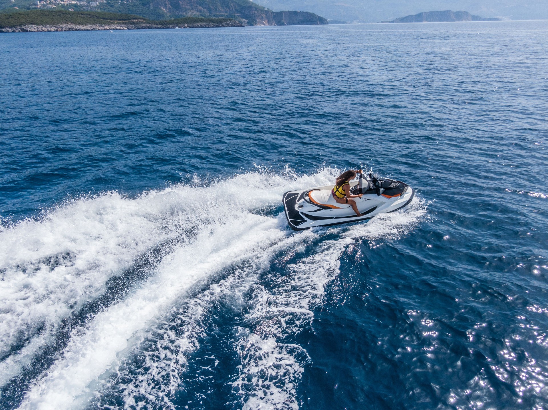 Aerial view of jet skier in blue sea. Jet ski in turquoise clear water racing stock photo